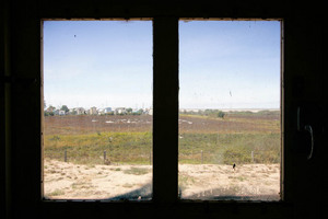 View of Milang shacks through railcart window