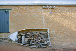 Old rowing boat used as a wood pile at Nor West Bend