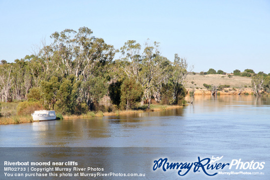 Riverboat moored near cliffs