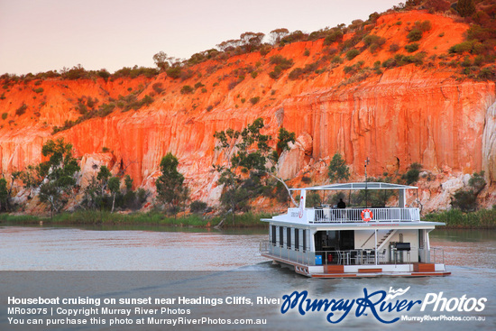 Houseboat cruising on sunset near Headings Cliffs, Riverland