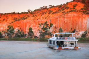 Houseboat cruising on sunset near Headings Cliffs, Riverland