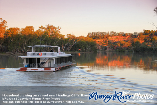 Houseboat cruising on sunset near Headings Cliffs, Riverland