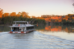 Houseboat cruising on sunset near Headings Cliffs, Riverland