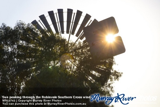 Sun peaking through the Robinvale Southern Cross windmill, Victoria