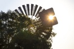 Sun peaking through the Robinvale Southern Cross windmill, Victoria