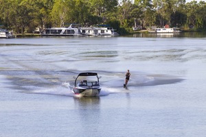 Water skiing behind wake boat at Paringa